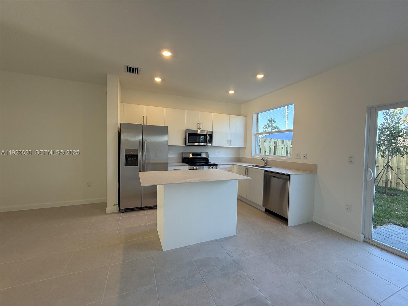 26846 Southwest 121st Court Homestead, FL 33032 - Photo 15 of 37 a kitchen with refrigerator and cabinets