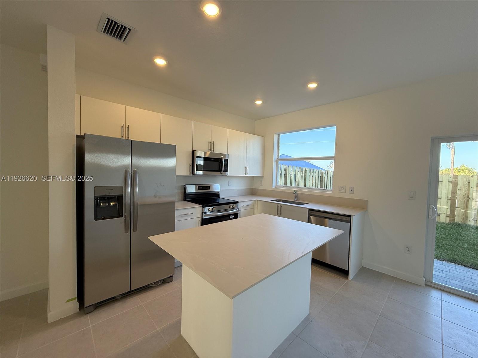 26846 Southwest 121st Court Homestead, FL 33032 - Photo 16 of 37 a kitchen with stainless steel appliances a refrigerator sink and stove