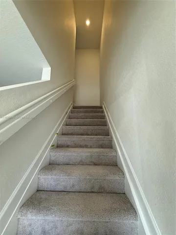 a bathroom with a shower sink vanity mirror and toilet