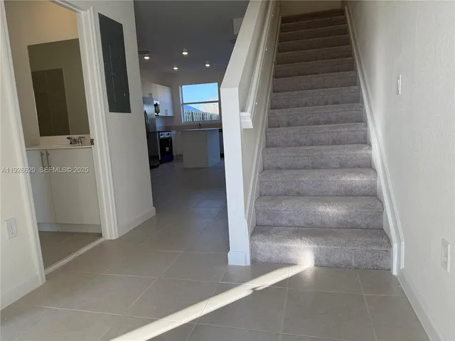 a view of entryway and hall with wooden floor