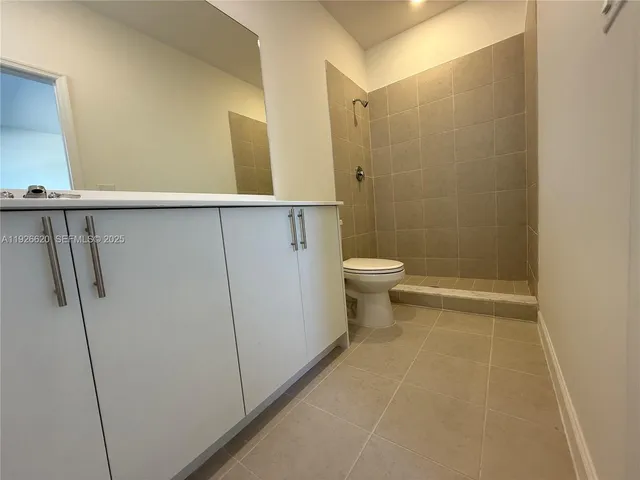 a white toilet sitting next to a bath tub