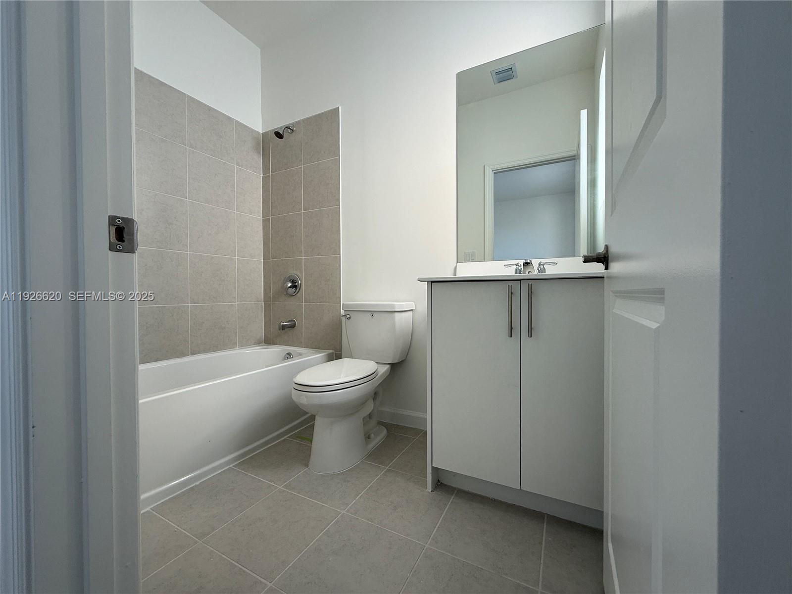 26846 Southwest 121st Court Homestead, FL 33032 - Photo 30 of 37 a bathroom with a toilet a sink and bathtub