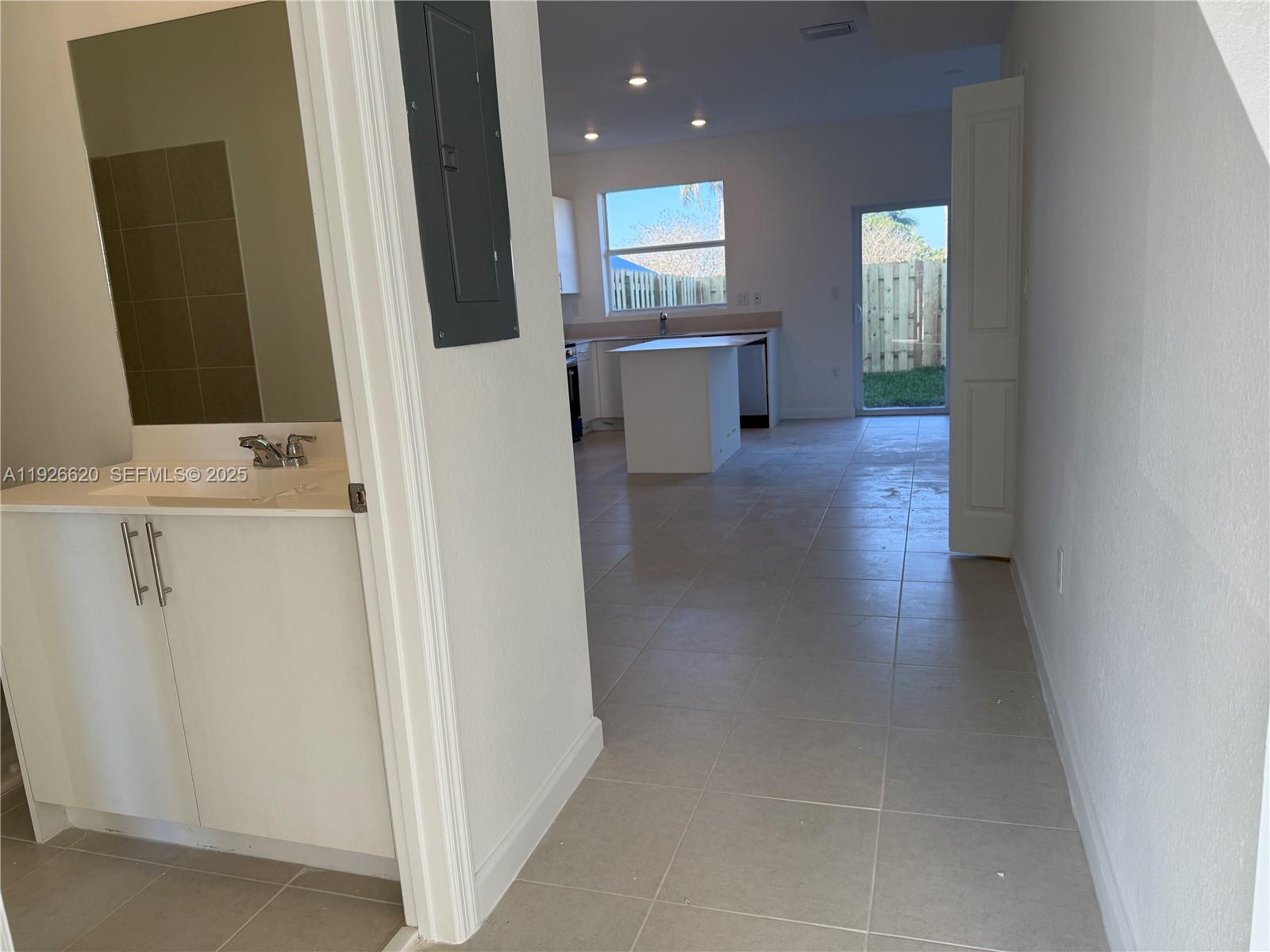 26846 Southwest 121st Court Homestead, FL 33032 - Photo 3 of 37 a view of a hallway to rooms and wooden floor