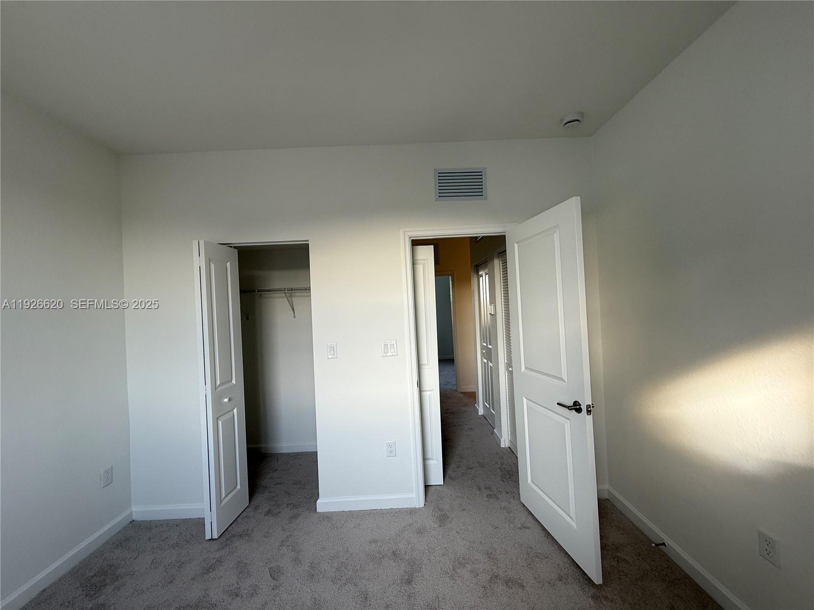 26846 Southwest 121st Court Homestead, FL 33032 - Photo 32 of 37 an empty room with closet and a bathroom