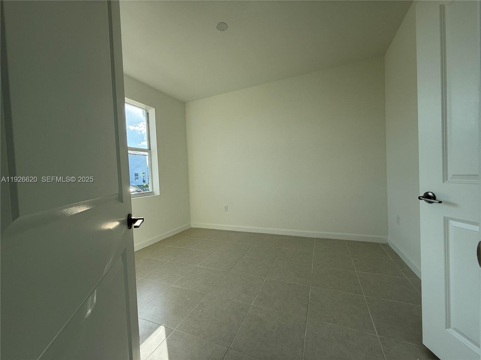 26846 Southwest 121st Court Homestead, FL 33032 - Photo 6 of 37 an empty room with windows