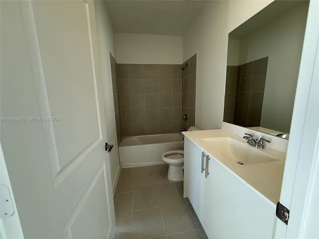 a view of a kitchen with a sink and dishwasher a refrigerator with wooden floor