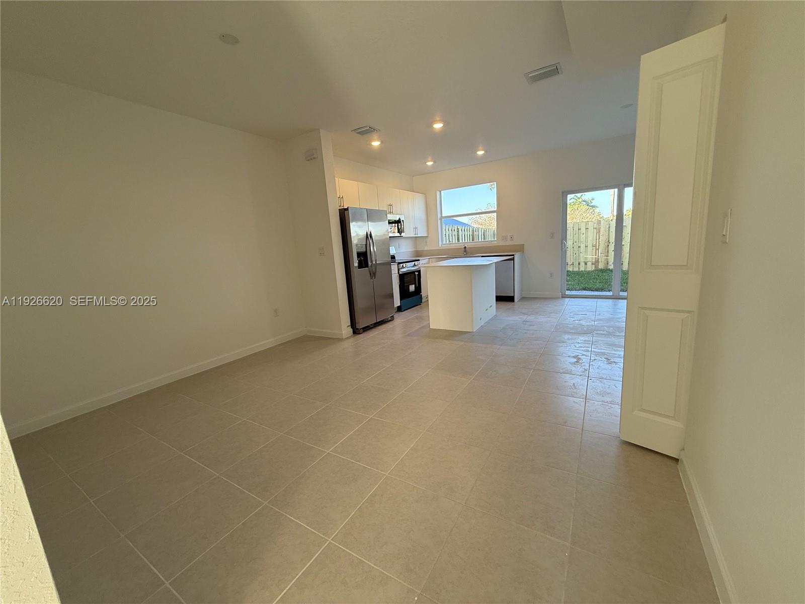 26846 Southwest 121st Court Homestead, FL 33032 - Photo 10 of 37 a view of a kitchen with a sink and dishwasher a refrigerator with wooden floor