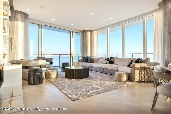 a living room with furniture and large windows