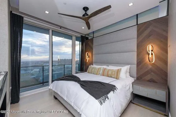 a bedroom with a large bed and a balcony view