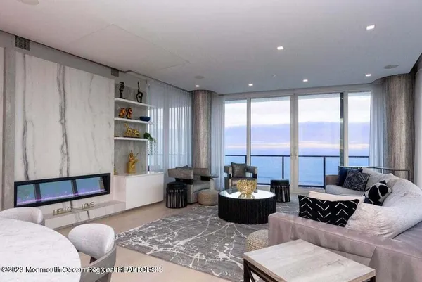 a living room with furniture large window and a table