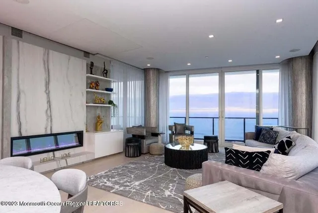 a living room with furniture large window and a table