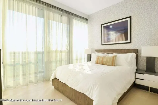 a bedroom with a large bed and a painting on the wall