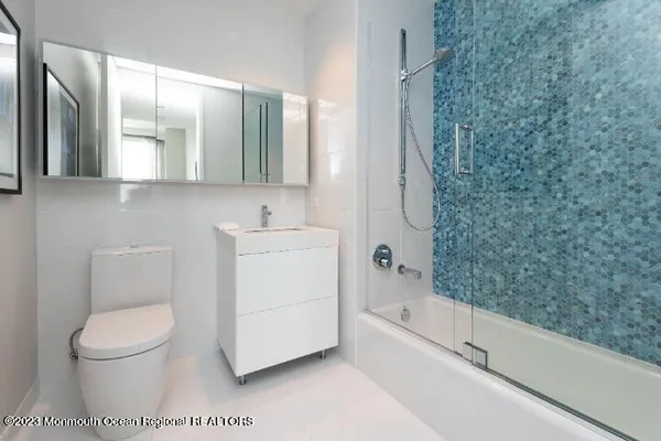a bathroom with a toilet a sink and bathtub