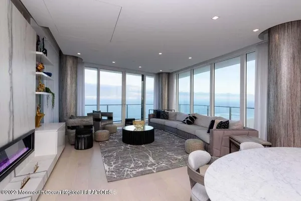 a living room with furniture and large windows