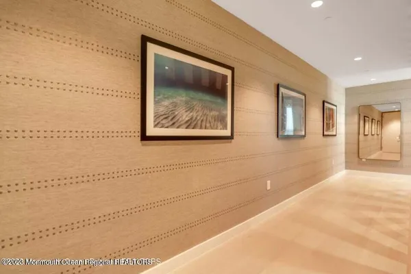 a view of a big room with wooden floor and windows