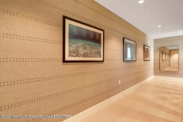 a view of a big room with wooden floor and windows