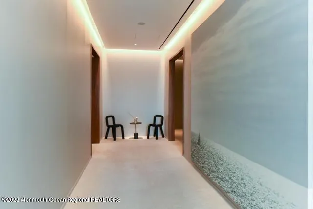 a living room with furniture a large window and flat screen tv