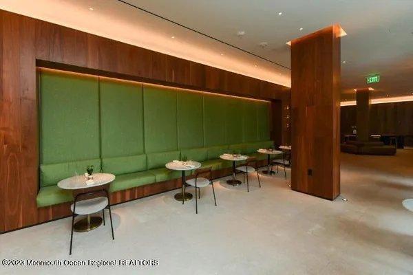 a living room with furniture a flat screen tv and a large window