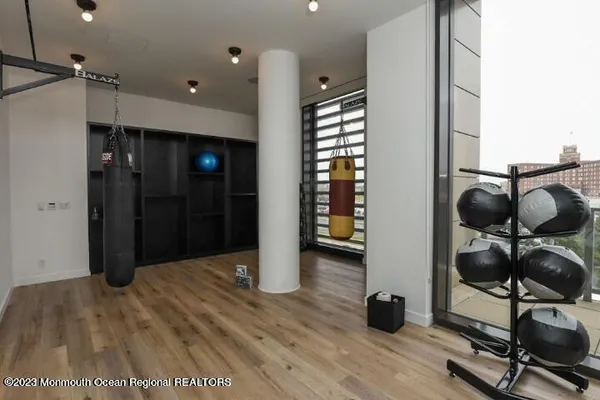 a living room with furniture a piano and a bookshelf