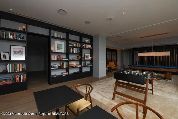 a dining room with furniture window and wooden floor