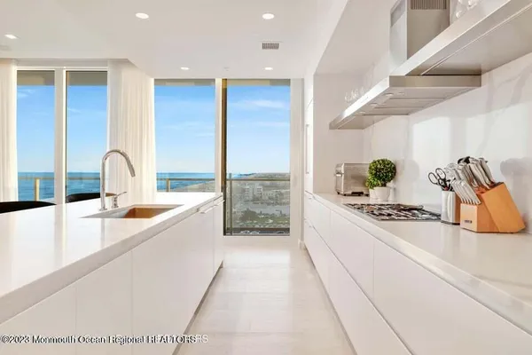 a large white kitchen with a large window