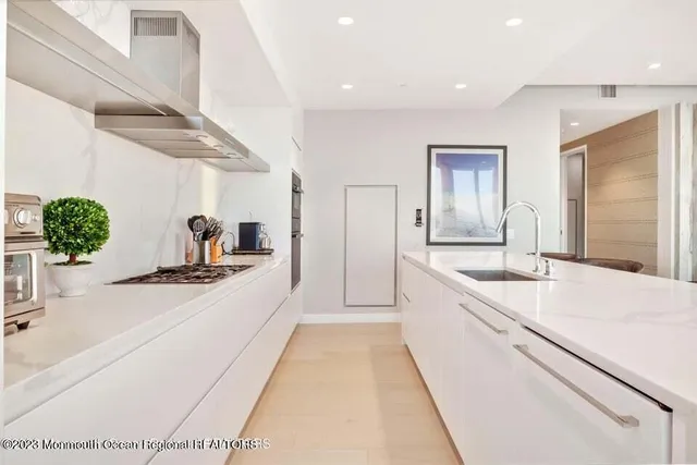 a large white kitchen with a large window