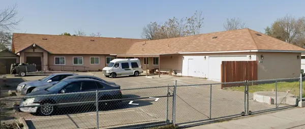 a front view of a house with parking space