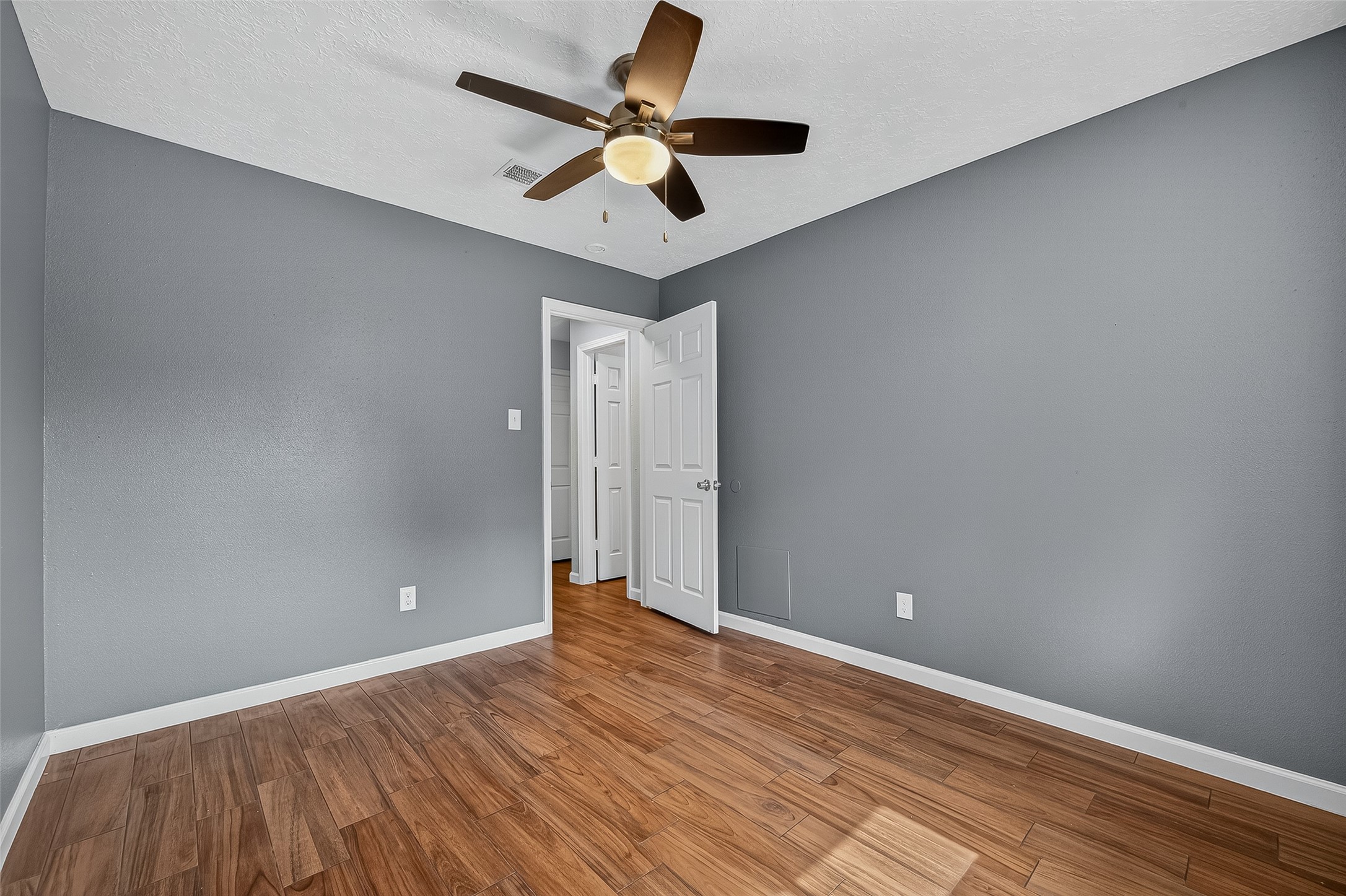 2719 Flintrock Circle Houston, TX 77067 - Photo 17 of 22 wooden floor in an empty room with a window