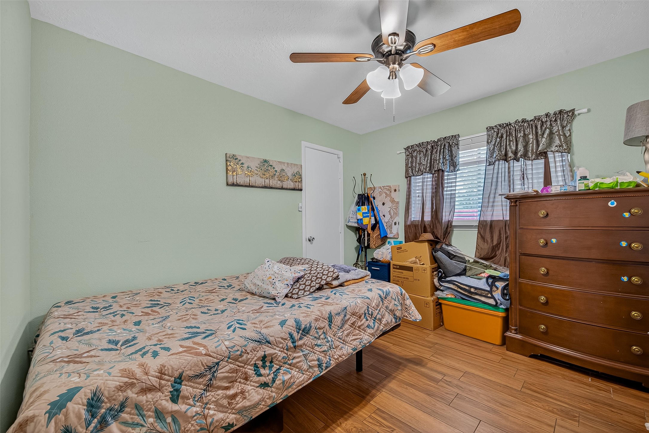 2719 Flintrock Circle Houston, TX 77067 - Photo 18 of 22 a bedroom with a bed and a dresser in it