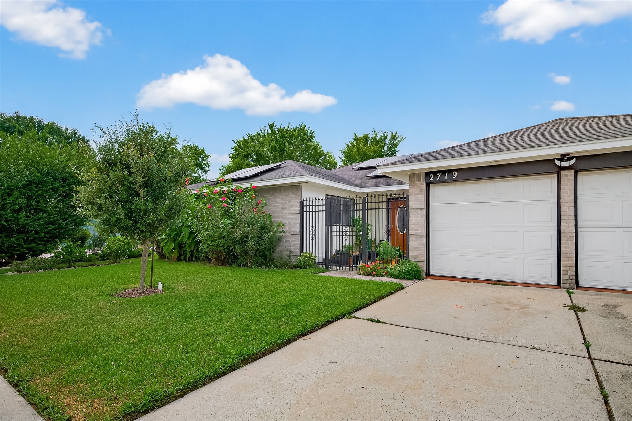 2719 Flintrock Circle Houston, TX 77067 - Photo 2 of 22 a front view of a house with a yard and garage