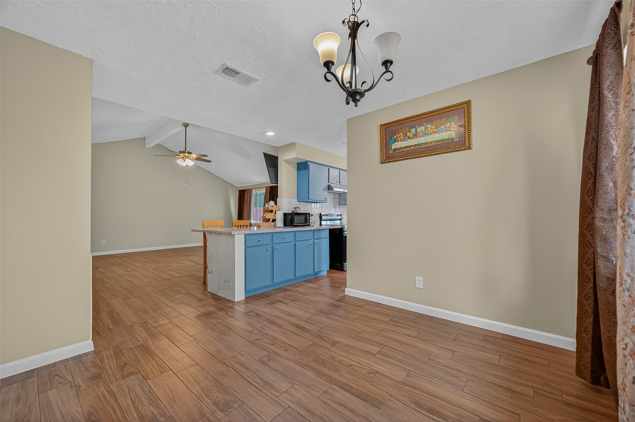 2719 Flintrock Circle Houston, TX 77067 - Photo 7 of 22 a view of a kitchen with a sink wooden floor and a refrigerator