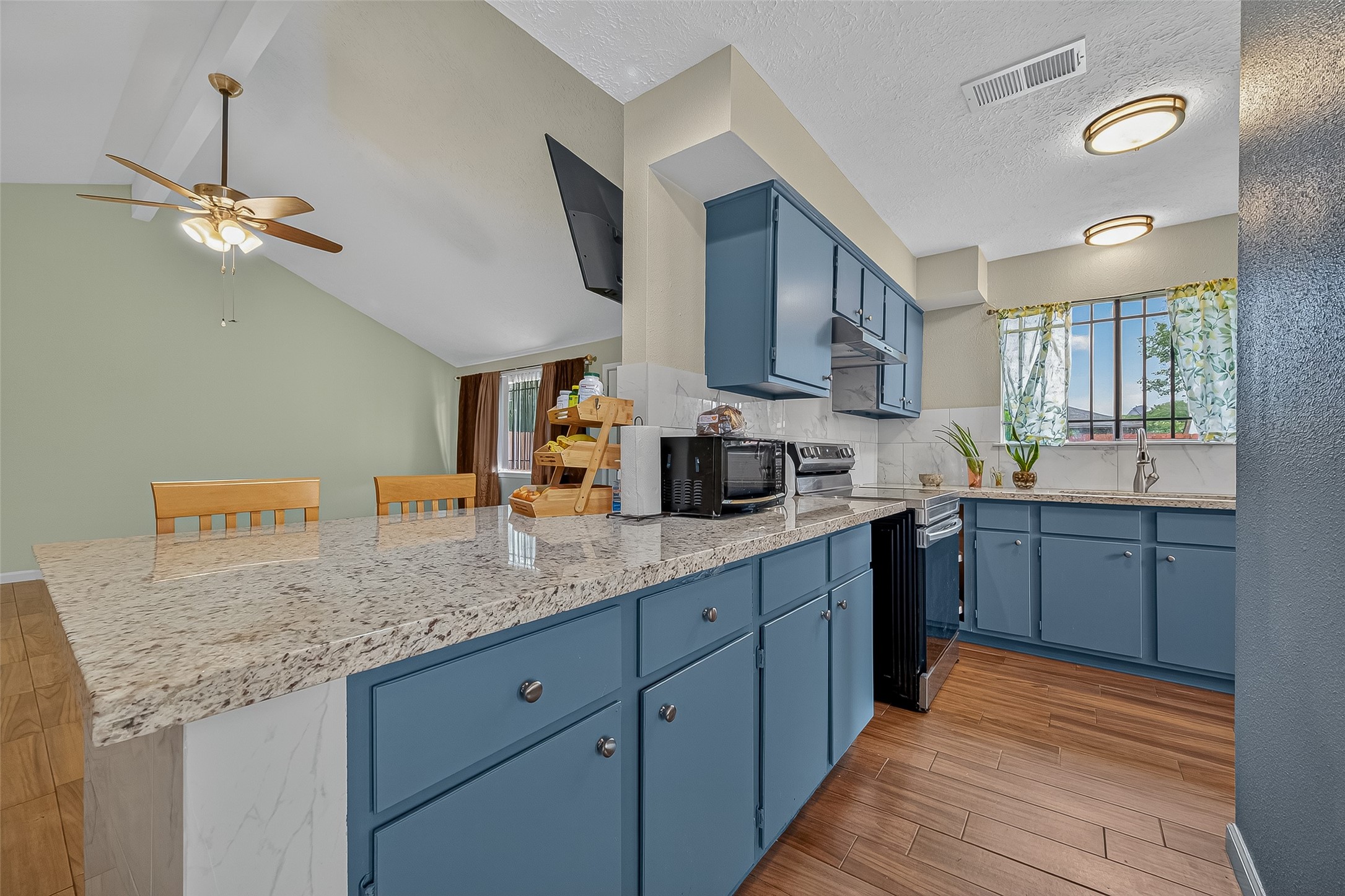 2719 Flintrock Circle Houston, TX 77067 - Photo 8 of 22 a kitchen with stainless steel appliances granite countertop a sink dishwasher a stove and a refrigerator with wooden floor