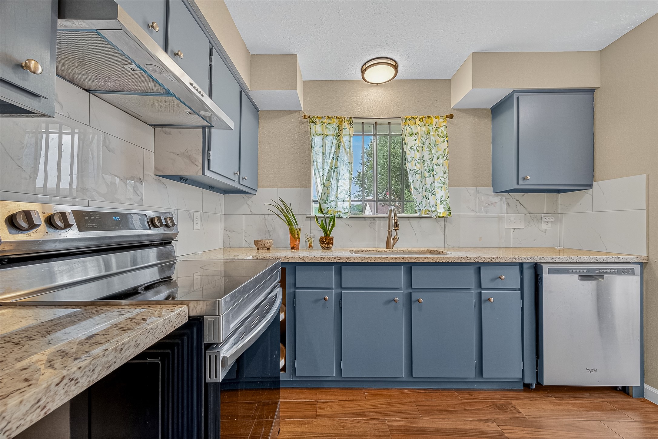 2719 Flintrock Circle Houston, TX 77067 - Photo 9 of 22 a kitchen with a sink cabinets and window