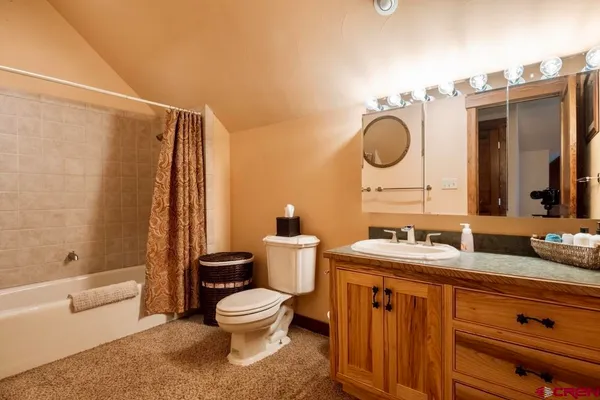 a living room with furniture a fireplace and a large window