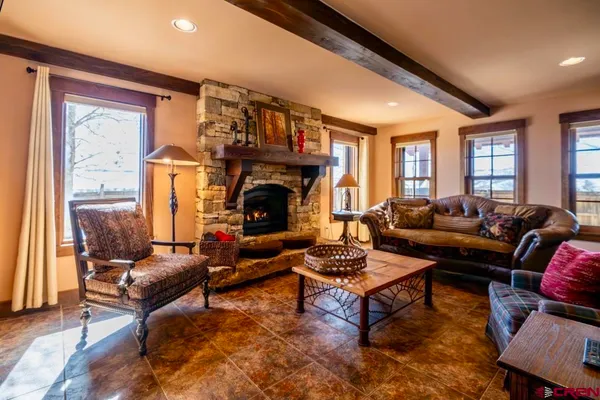 a kitchen with a table chairs and wooden floor