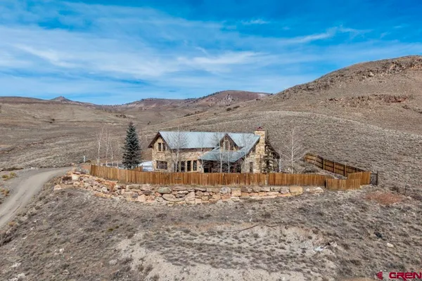 a view of a house with a snow in the background
