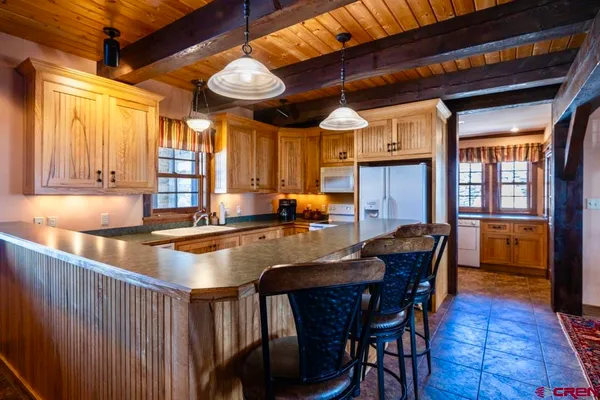 a view of a kitchen with stainless steel appliances and cabinets