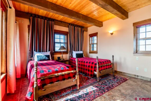 a bedroom with a bed and a couch