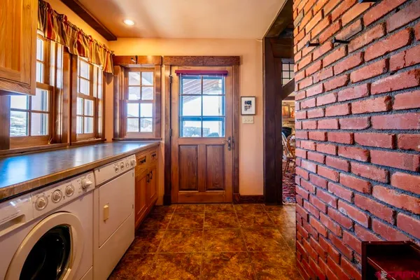 a view of a dirt road with large trees