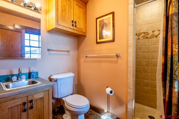 a view of a dry yard with wooden fence
