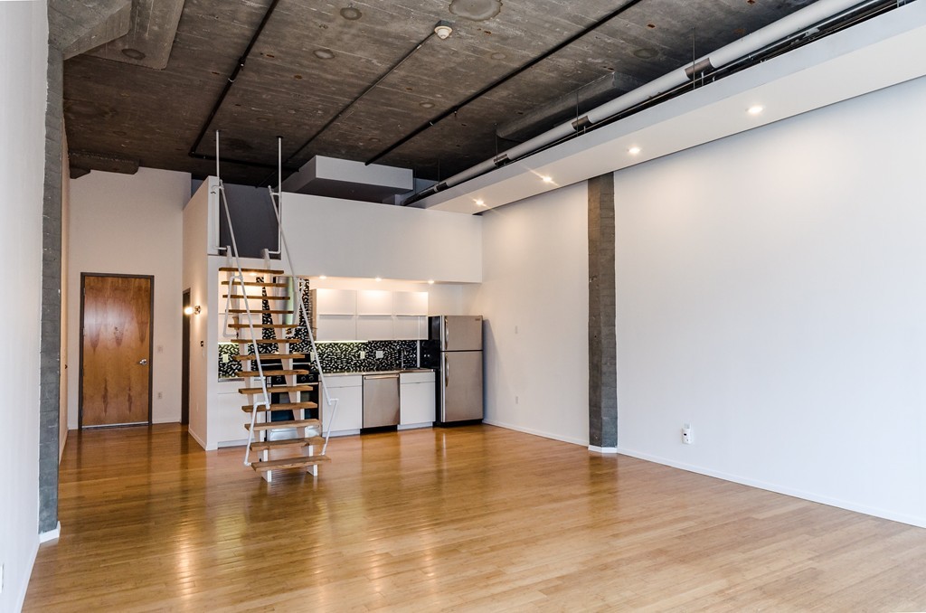 156 Porter Street, Unit 236 Boston, MA 02128 - Photo 4 of 16 a view of empty room with wooden floor