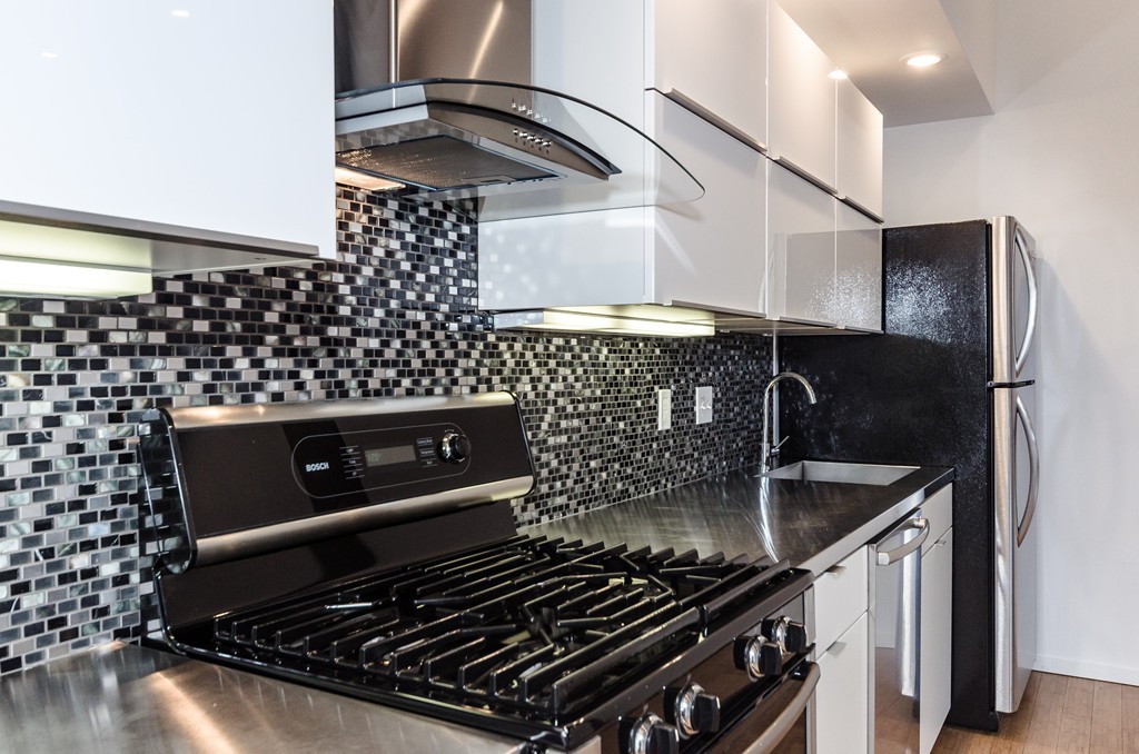 156 Porter Street, Unit 236 Boston, MA 02128 - Photo 5 of 16 a kitchen with a sink stove and cabinets