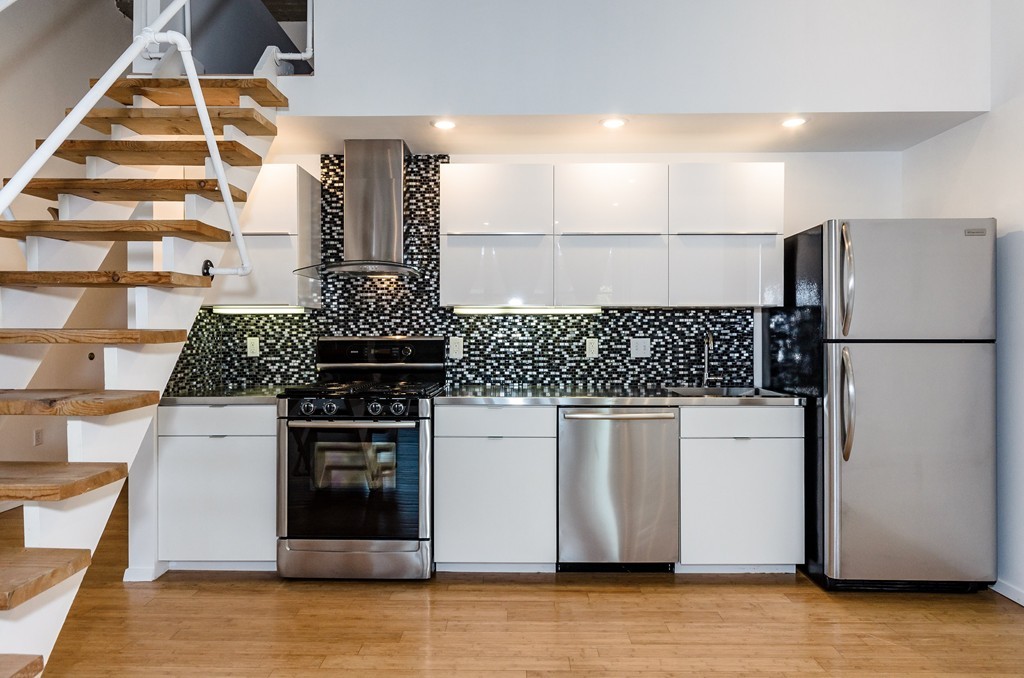 156 Porter Street, Unit 236 Boston, MA 02128 - Photo 6 of 16 a kitchen with stainless steel appliances granite countertop a refrigerator and a stove