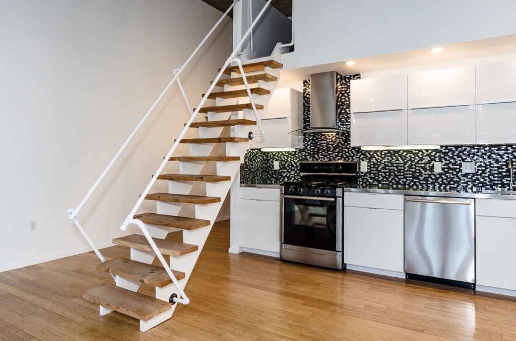 156 Porter Street, Unit 236 Boston, MA 02128 - Photo 7 of 16 a view of a kitchen with wooden floor and electronic appliances