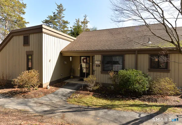 a view of a house with backyard porch and sitting area