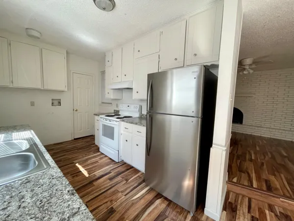 a kitchen with a refrigerator sink and stove