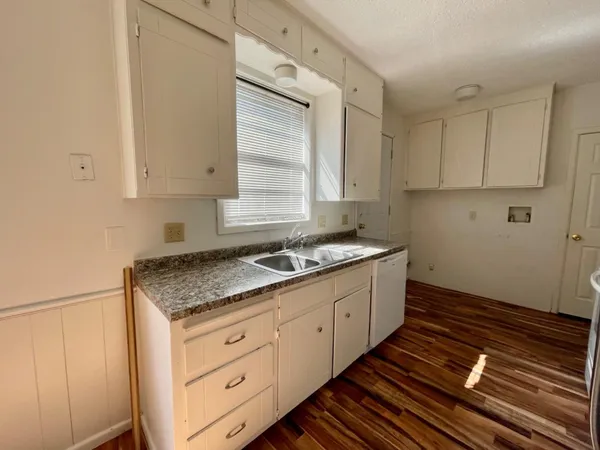 a kitchen with sink stove and cabinets