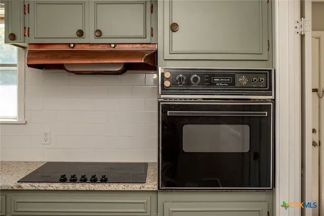a close view of a stove and cabinets