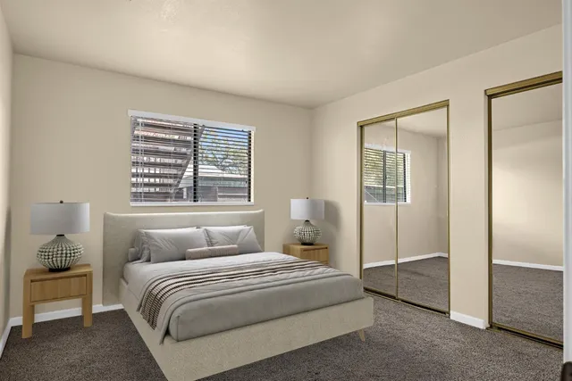 a bedroom with a large bed and a window