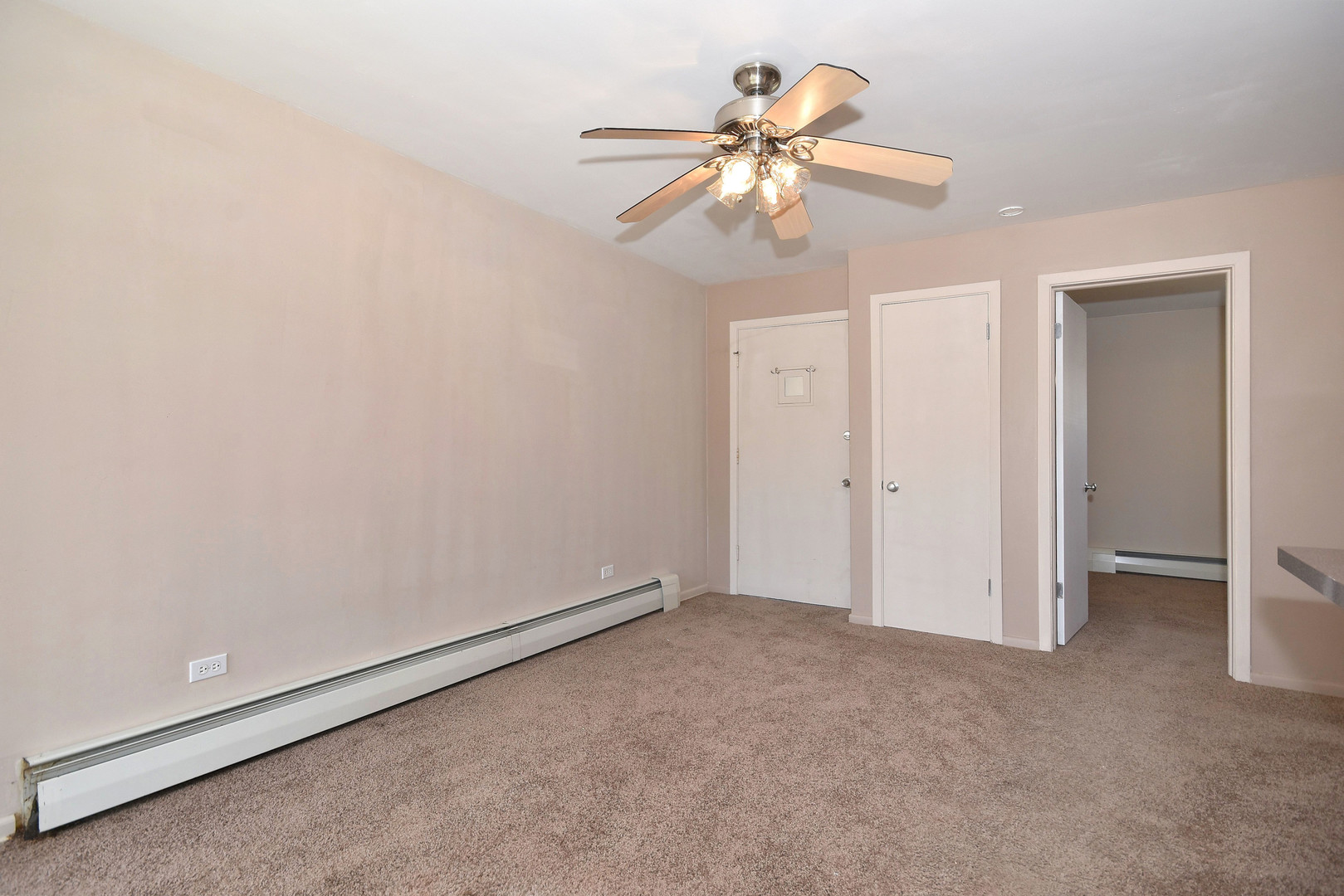 6152 West Rosedale Avenue, Unit 1 Chicago, IL 60646 - Photo 14 of 18 an empty room with a chandelier fan and closet